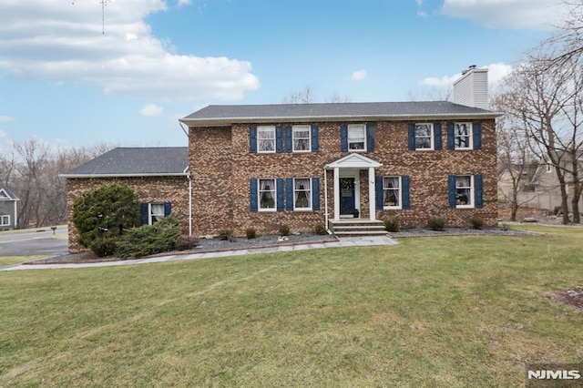 colonial inspired home with a front yard