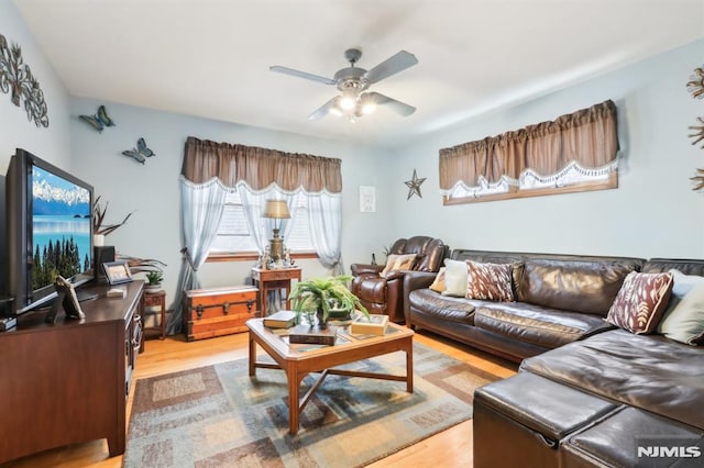 living room featuring ceiling fan and light hardwood / wood-style flooring