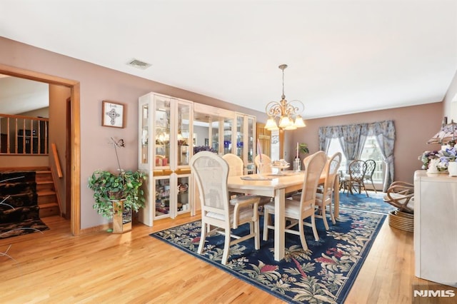 dining room featuring an inviting chandelier and hardwood / wood-style floors