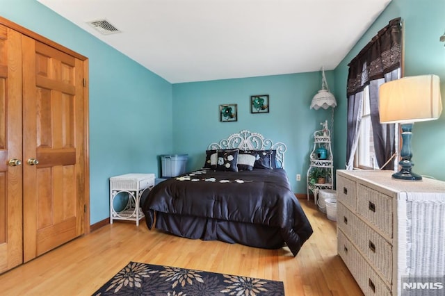 bedroom featuring a closet and light hardwood / wood-style flooring