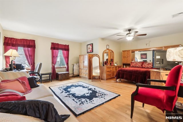 bedroom with ceiling fan and wood-type flooring