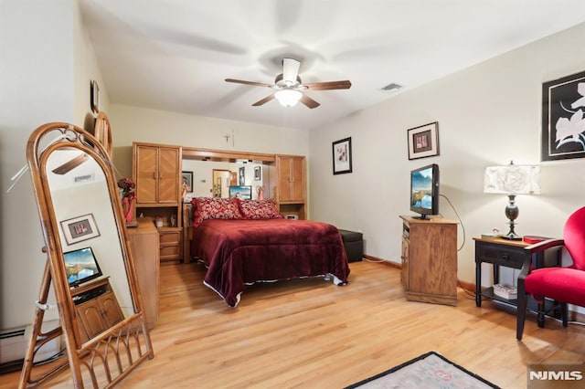 bedroom with ceiling fan and light hardwood / wood-style floors