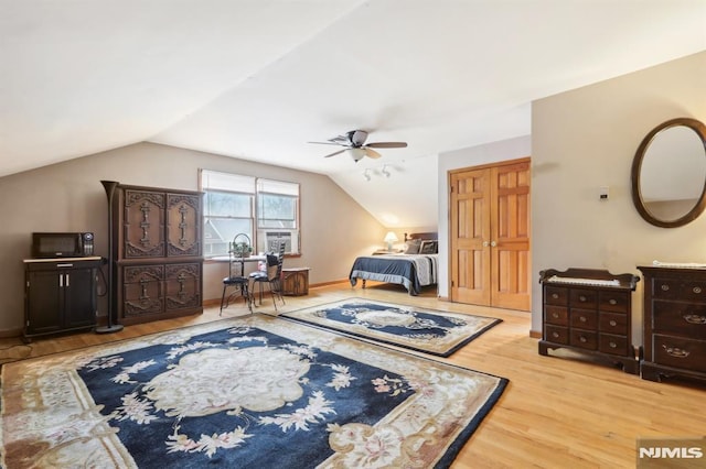 bedroom featuring lofted ceiling and light hardwood / wood-style floors