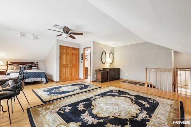 bedroom with lofted ceiling, ceiling fan, and light hardwood / wood-style floors