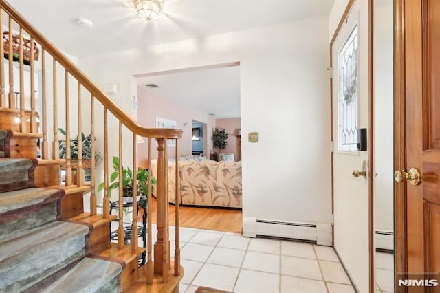 entryway featuring a baseboard radiator and light tile patterned flooring