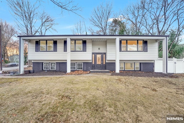 raised ranch featuring a front lawn