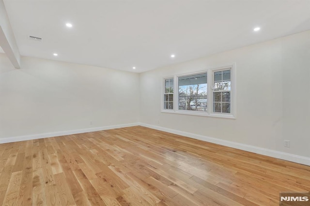 empty room with light hardwood / wood-style flooring