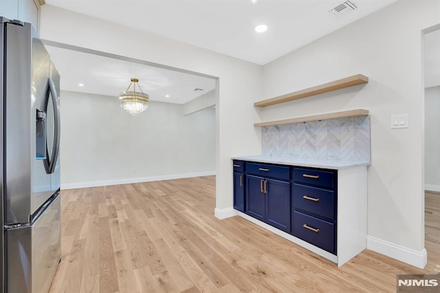 kitchen featuring light hardwood / wood-style flooring, a chandelier, stainless steel fridge with ice dispenser, backsplash, and blue cabinetry