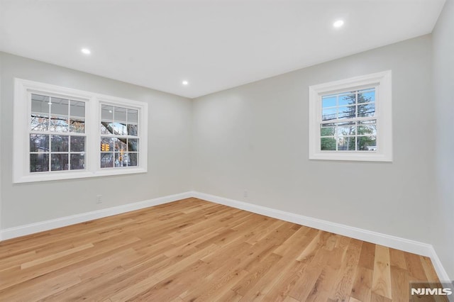 empty room with light hardwood / wood-style flooring