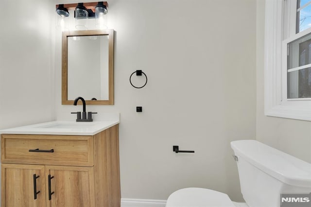 bathroom featuring toilet and vanity