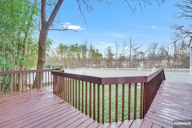 wooden terrace featuring a yard