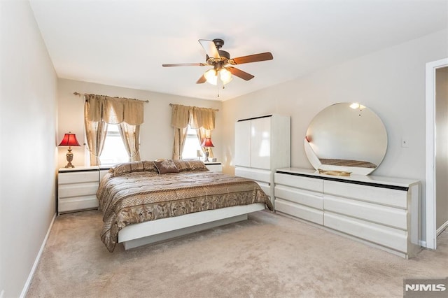 bedroom with light carpet and ceiling fan