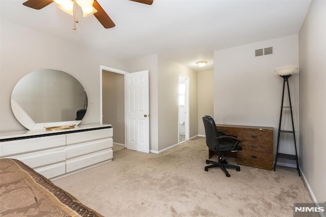 carpeted home office featuring ceiling fan