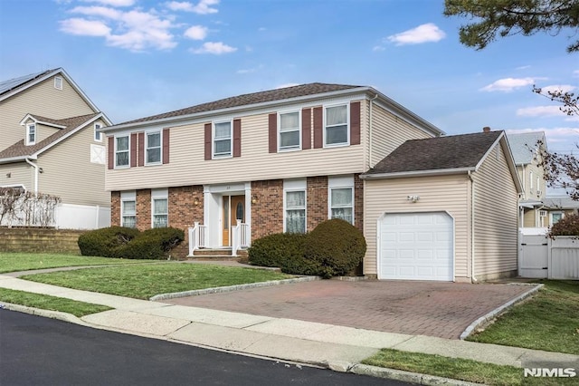 view of front of home with a front yard and a garage