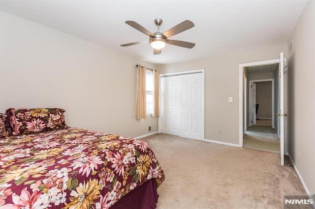 carpeted bedroom with ceiling fan and a closet