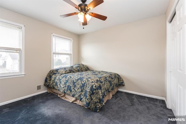 carpeted bedroom with a closet and ceiling fan