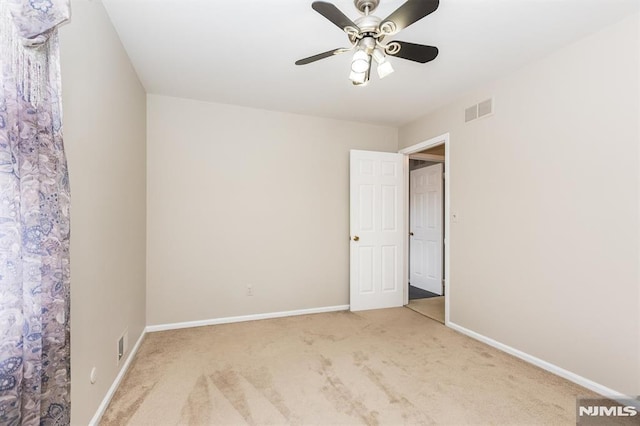 empty room featuring ceiling fan and carpet flooring