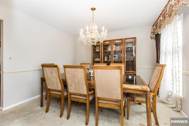 dining area with an inviting chandelier and carpet floors