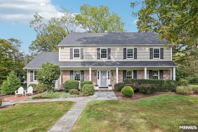 colonial inspired home featuring a front yard