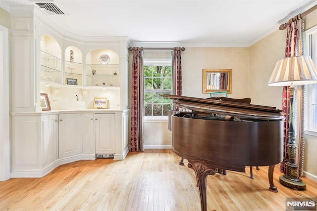 miscellaneous room with light hardwood / wood-style floors and crown molding