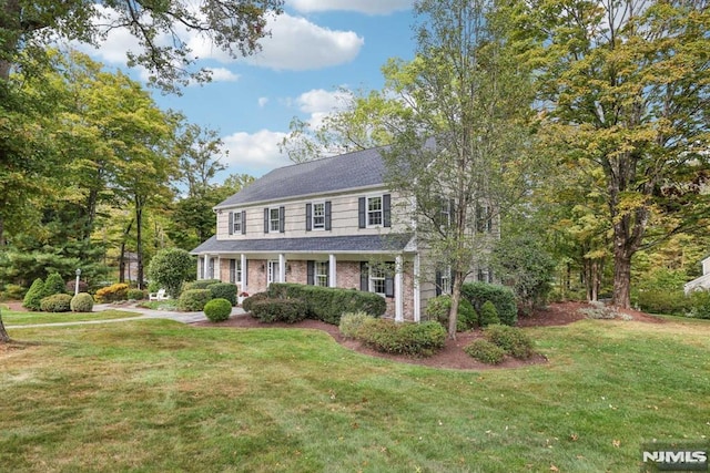 colonial house with covered porch and a front lawn