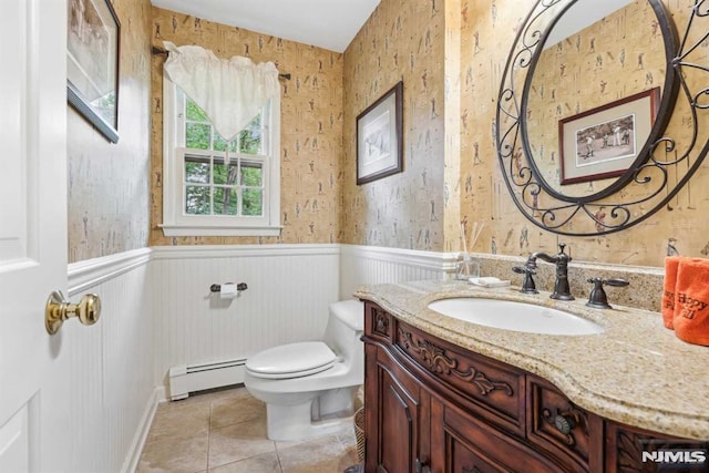 bathroom featuring vanity, toilet, a baseboard radiator, and tile patterned floors