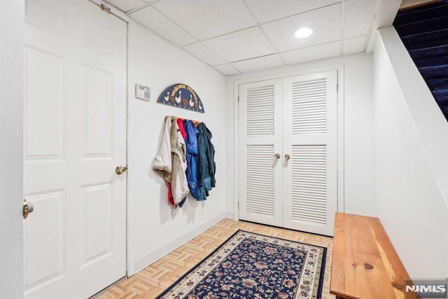 interior space featuring a paneled ceiling and parquet floors