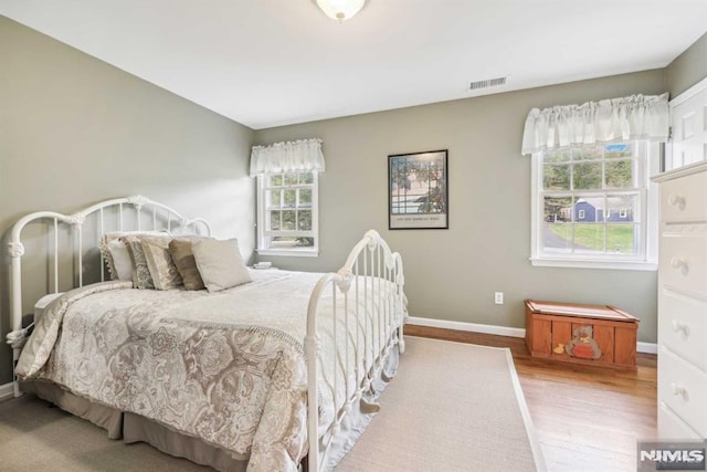 bedroom with hardwood / wood-style floors