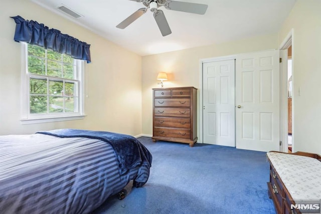 bedroom with ceiling fan, a closet, and dark carpet