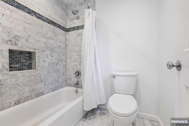 bathroom featuring shower / bath combo with shower curtain and toilet