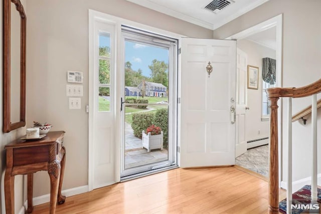 entryway with crown molding, light wood-type flooring, and a baseboard radiator