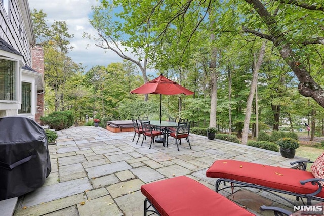 view of patio / terrace with a hot tub and grilling area