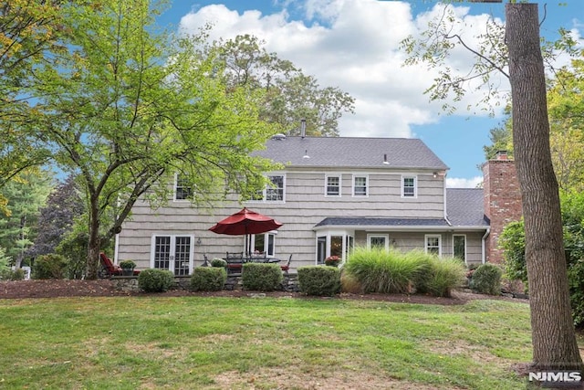 back of house featuring a yard