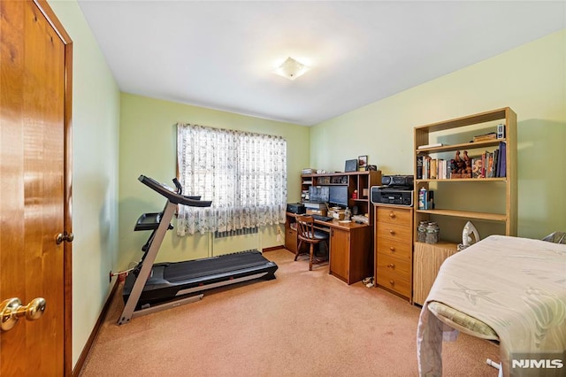 exercise area with light colored carpet and radiator