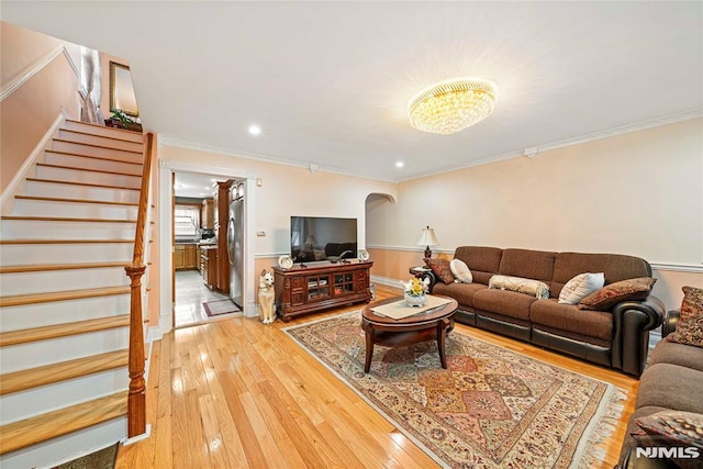 living room with ornamental molding and hardwood / wood-style flooring