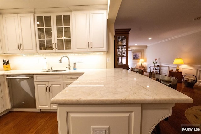 kitchen featuring white cabinets, dishwasher, sink, and ornamental molding