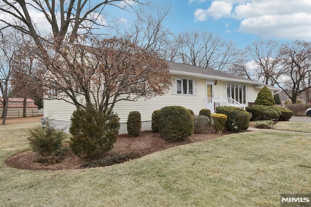 view of side of home featuring a yard