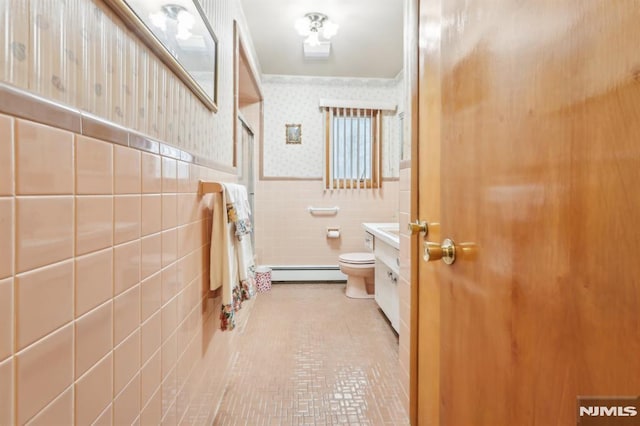 bathroom featuring toilet, tile patterned flooring, tile walls, a baseboard radiator, and vanity