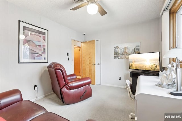 interior space featuring a textured ceiling, ceiling fan, and carpet