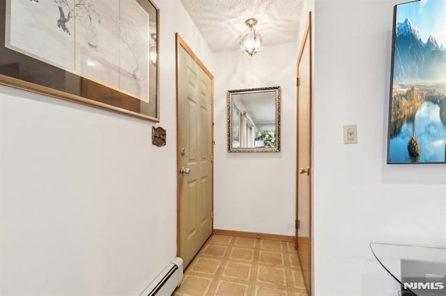 doorway to outside featuring a textured ceiling