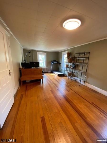 rec room with radiator heating unit and hardwood / wood-style flooring