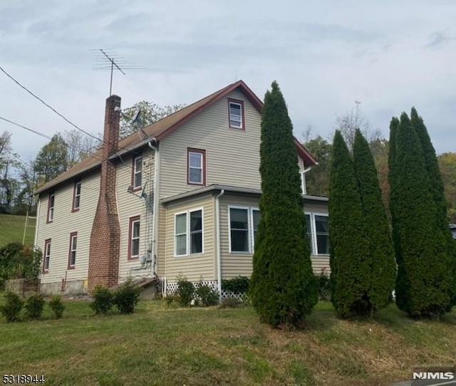 rear view of house with a lawn