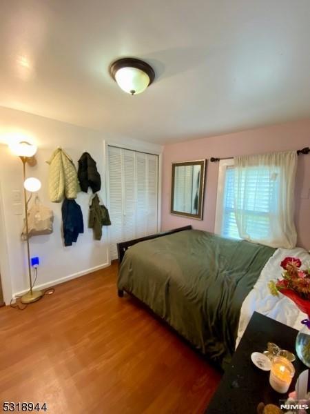 bedroom featuring hardwood / wood-style floors and a closet