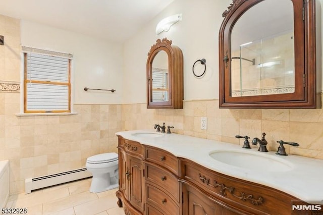 bathroom featuring vanity, tile walls, toilet, tile patterned floors, and a baseboard radiator