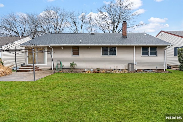 back of house with central air condition unit, a patio, and a yard