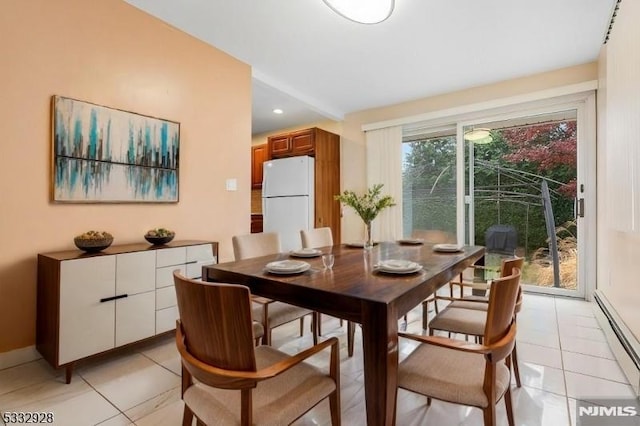 dining room featuring baseboard heating and light tile patterned floors