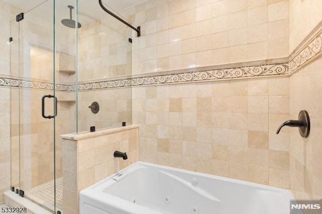 bathroom featuring shower with separate bathtub