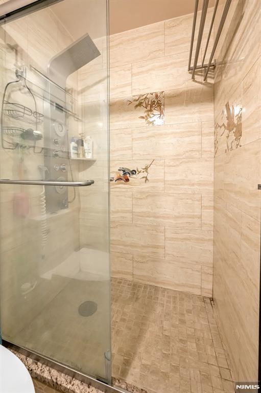 bathroom featuring toilet and walk in shower