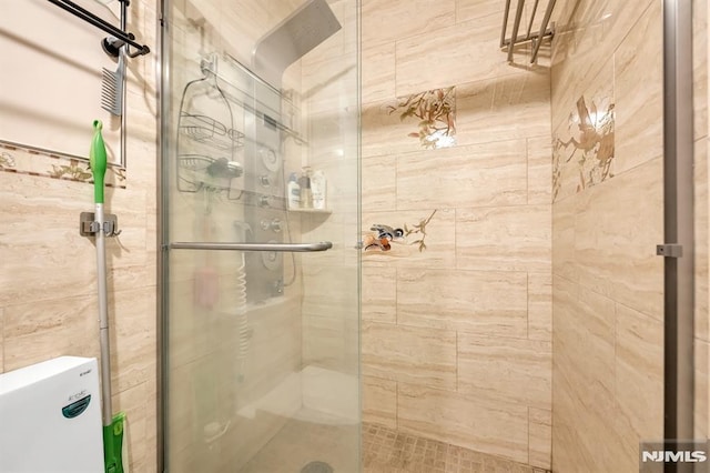 bathroom featuring a shower with shower door