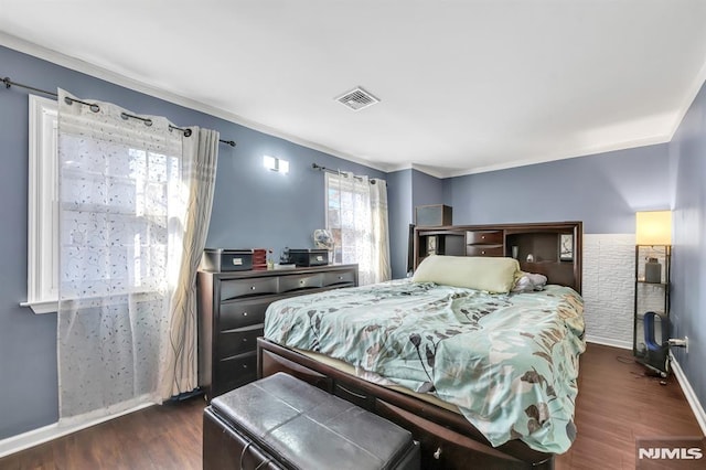 bedroom featuring multiple windows, crown molding, and dark hardwood / wood-style floors